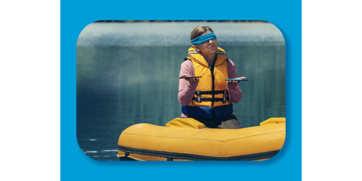 photo of a blindfolded woman in a inflatable boat holding two phones